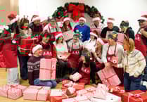 £1 million lottery winners from Brecon help pack toys for children in need