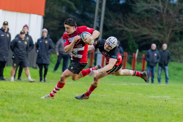 Lewis Rees breaks through the home defence to score Brecon's first try