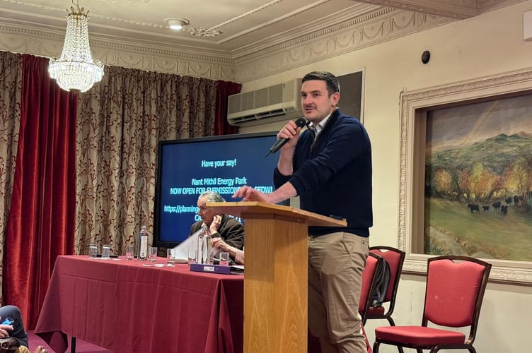 James Evans MS addresses attendees during a packed public meeting