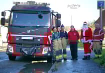 Firefighters turn Santa for a day to help local families