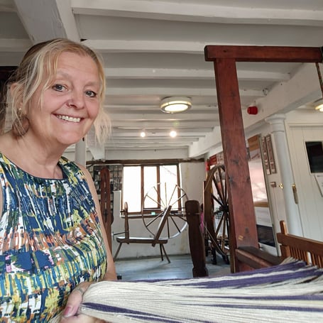 Emma Allin-Thomas with some of her woven, naturally dyed, Welsh yarn products.