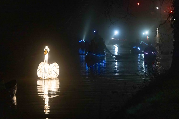 The illuminated swan on the canal
