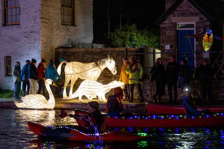 Boaters decorated their vessels with lights as part of the celebrations. Behind are some of the illuminated animals