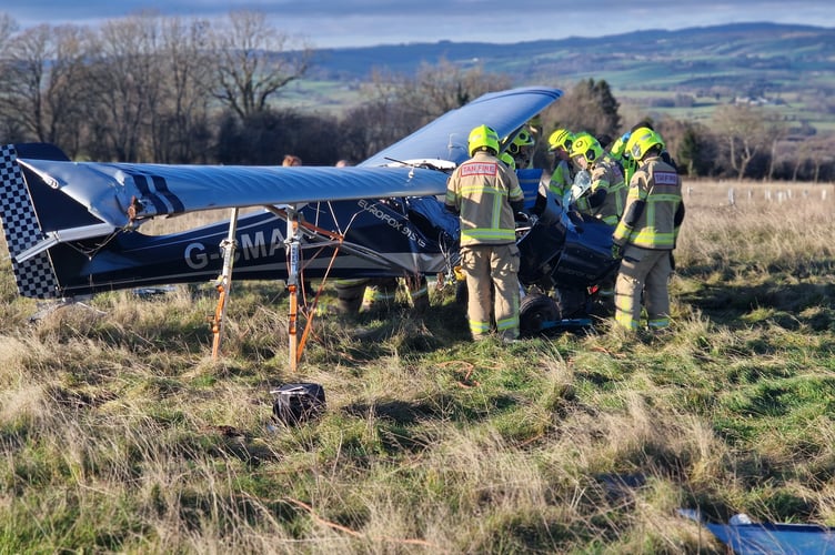 crews work to free the pilot of a light aircraft following a crash-landing on Saturday morning.