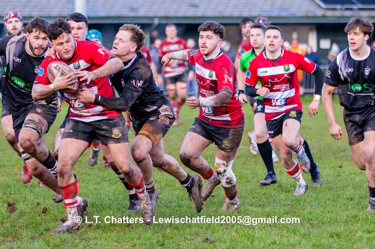 RHYS Dvies breaks through a tight defence to set up Brecon's  1st try.