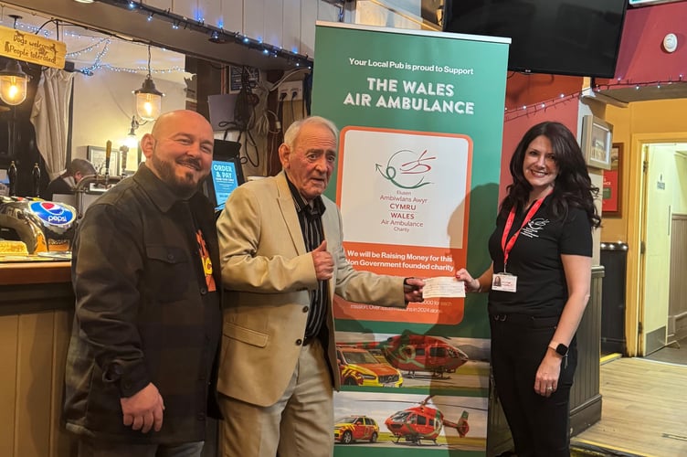 Fred Richards (centre) with Pontardawe Inn landlord Sion Partridge and Natalie Richards from the Wales Air Ambulance
