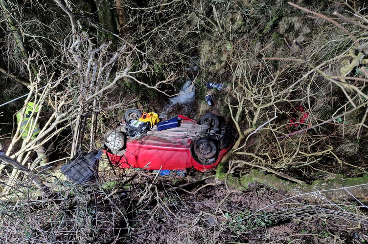 Firefighters used specialist equipment to free a trapped driver from the overturned vehicle