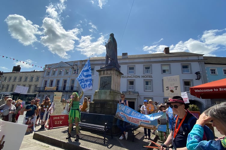A protest against river pollution in Brecon, held back in 2023