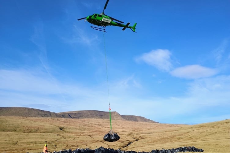 Wardens use a helicopter to airlift materials for conservation work in the Park.