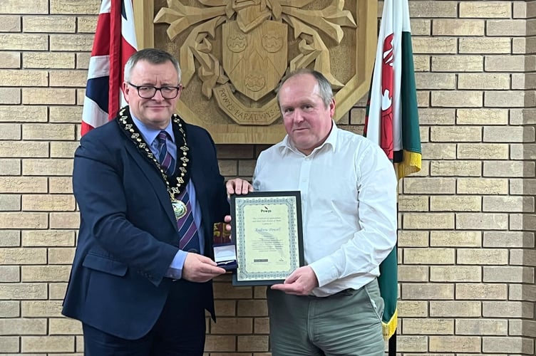 Andrew Powell receiving his award from Cllr William Powell