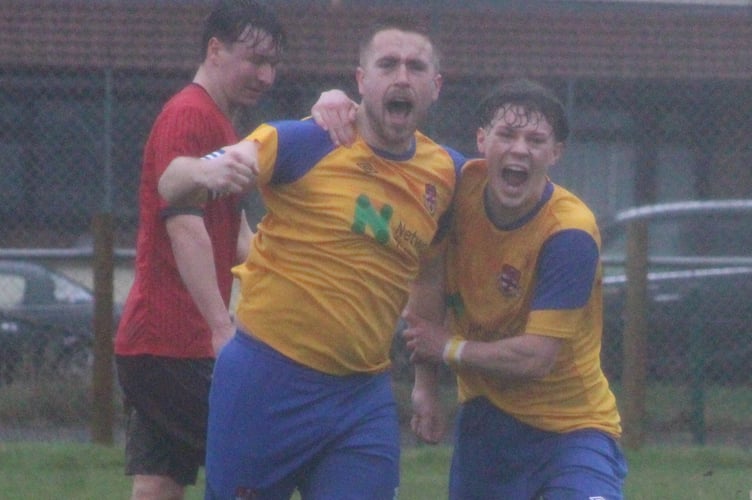 Knighton Town captain Jack Brindley celebrates after scoring his second goal in the 3-0 win at Talgarth Town