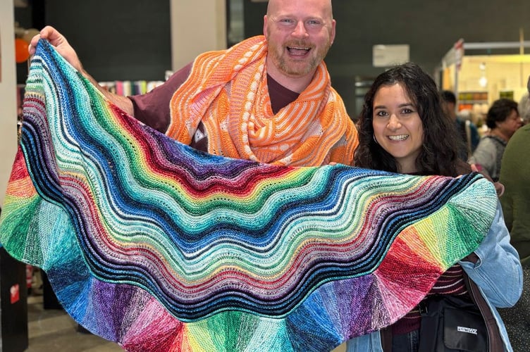 Knitwear designer Stephen West from Stephen and Penelope in Amsterdam with a customer and one of his creations