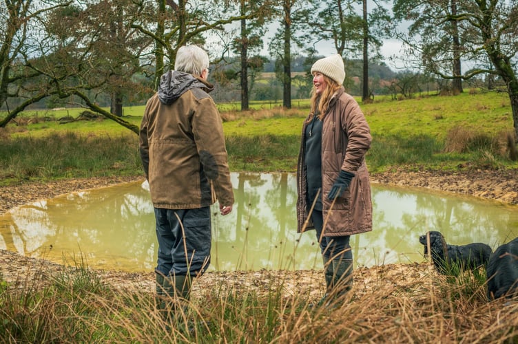Freshwater Habitats Trust Project Manager Geraint Watkins at the new pond with Llangammach Wells farmer Caroline Wilson.
