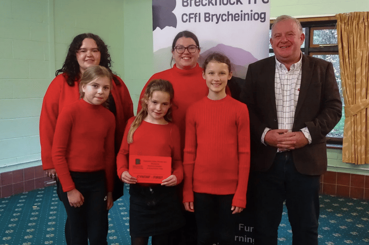 Members of the winning choir: Mollie Hughes, Sian Healey, County President Gwyn Prothero, Elin Woods, Beth Thompson and Darcey Boulton