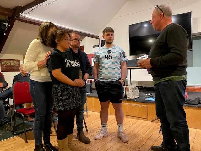 Talgarth Choir chairman Dermont Doyne presents a cheque for £201.50 to the family of Tiny Harding in aid of Prostate Cancer