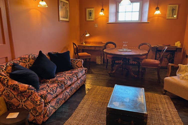 The earth-red living room of Flat 2, The Retiring Rooms