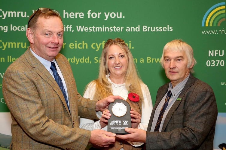 Last year’s award-winner Jess Williams is pictured with Bryn Hughes, National Sheep and Beef Specialist for Wynnstay PLC (left), and former NFU Cymru Rural Affairs Board Chair Hedd Pugh (right)