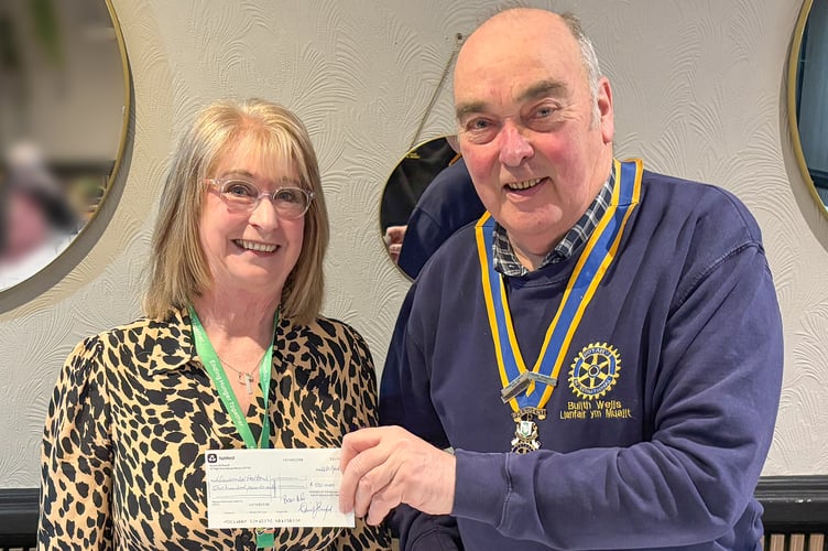 Rotary president Hugh Garner presents a £500 cheque to Lynne Frost of Llandrindod Wells Foodbank