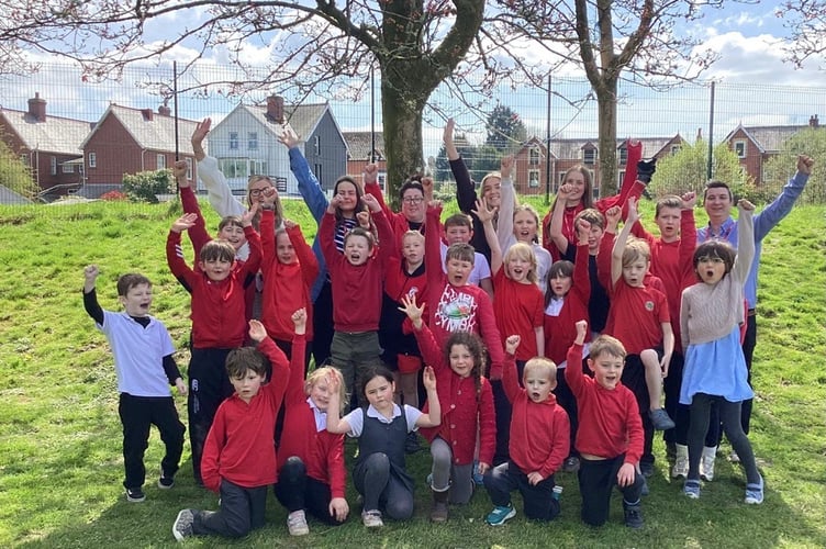 Pupils and staff at Ysgol Dolafon celebrate after the school was removed from Estyn’s list of schools requiring significant improvement following a positive monitoring visit