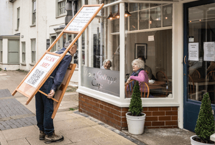 Local artist Mark Richards walks along Presteigne High Street wearing a large QR code to promote the Presteigne and Norton UK Town of Culture 2028 bid and encourage residents to take part in the community survey