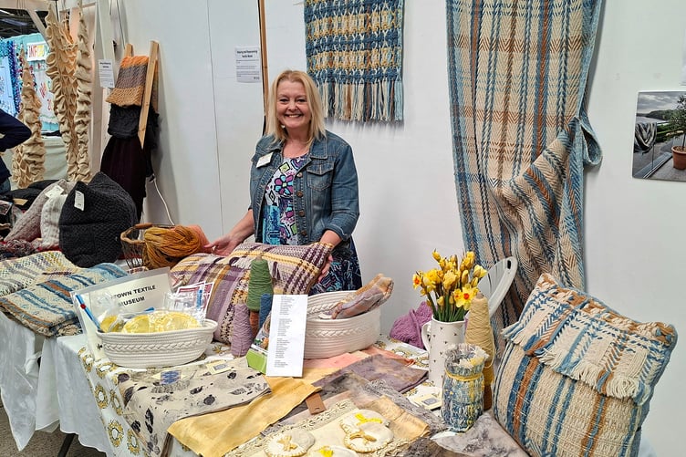 Emma Allin-Thomas with some of her woven, naturally dyed, Welsh yarn products.