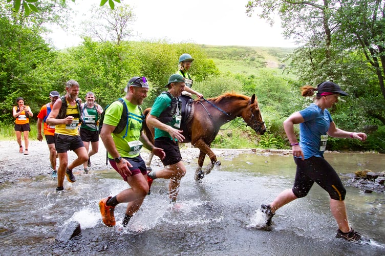 Runners and rider in the annual Man versus Horse race.