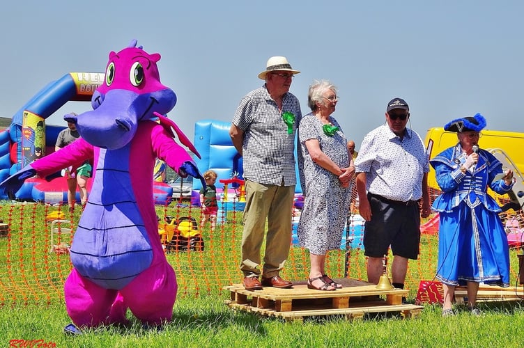 Town Crier Jan Swindale gives the traditional “Oyez” call at the opening of Llanbister Show, joined by a Welsh dragon, as this year’s joint presidents Margaret and James Grieve look on