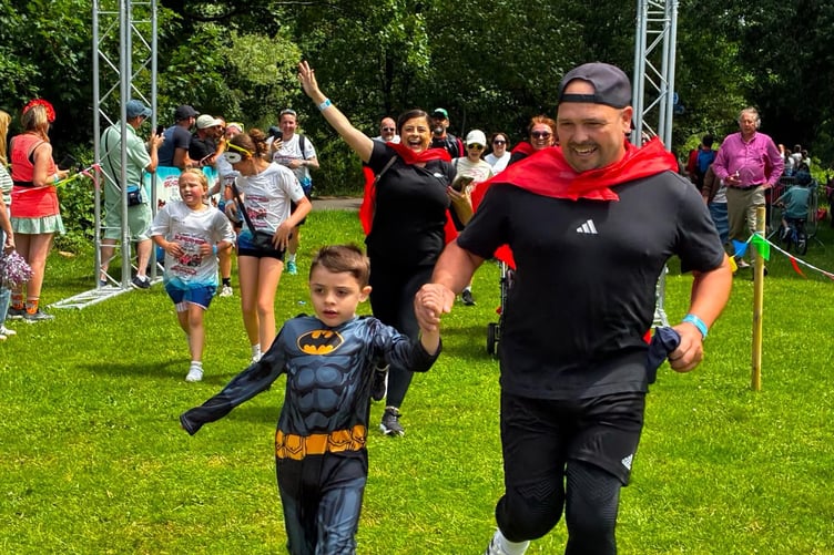 Freddie Julian from Brecon crosses the finish line with his dad at the Noah’s Ark Children’s Hospital Charity Superhero 5K Fun Day in Cardiff