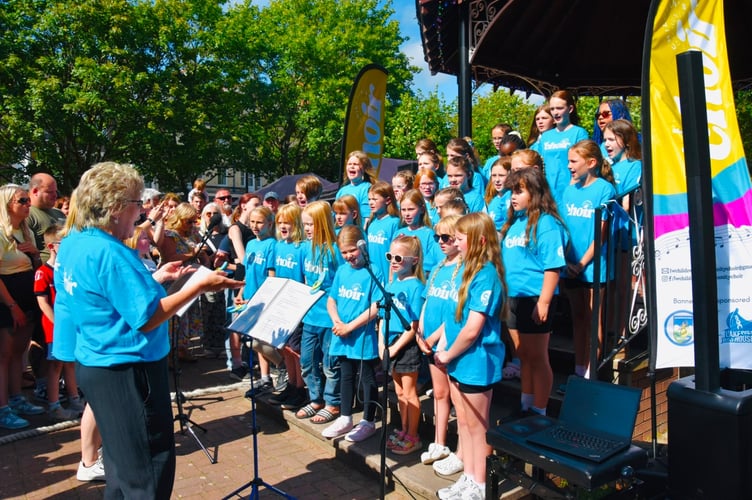 The choir members proudly wore their new T-shirts for their first public performance
