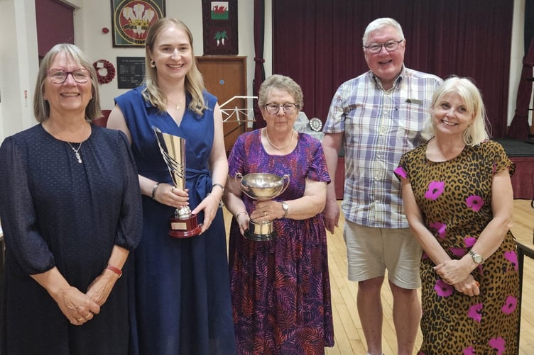 Rhiannon Jones receives the John Robinson Cup from Mary Robinson, alongside evening president Ydwena Jones and the adjudicators