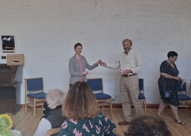Claire Boot of the URC Wales Synod hands the keys to Glyn Tarell Community Council chair Paul Woods