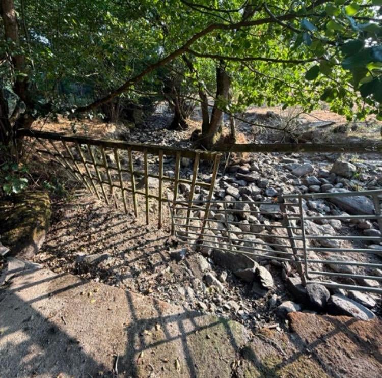 A riverbed running dry on farmland near Rhayader