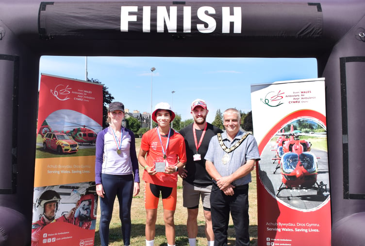 Lisa Cook of Charcroft Electronics presents an age category award to Charlie Coleman, alongside Hugh Tamlyn of Wales Air Ambulance and Alan Waller, Mayor of Builth Wells