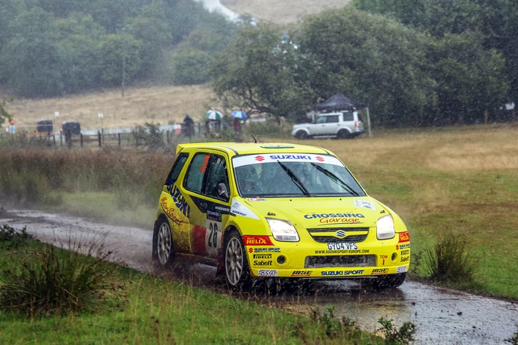 Christian Prynne and Aled Richards push the Suzuki Ignis through a torrential downpour during the final stage to secure first in class