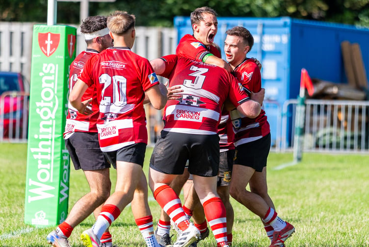 Brecon players celebrate the winning try