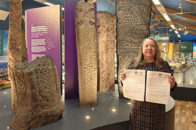 Cara Trevor, Strategic Lead for Museums, with the letters confirming accredited status at y Gaer in Brecon