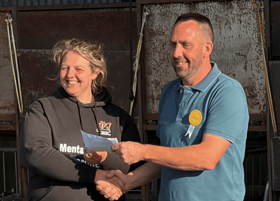 Hundred House Show chairman Andrew Bevan presents a £3,000 cheque to Jess from the DPJ Foundation