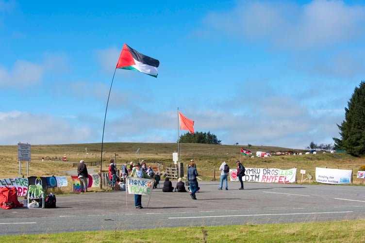 21/09/2026. Builth Wells, Wales, UK. Peace campaigners stand in unity with displaced people worldwide in a vigil, for the All Wales International Day of Peace at the Sennybridge Military Training Area (SENTA) on the Mynydd Epynt upland region of Mid Wales near Builth Wells in Powys, UK. This 31,000 acres of land is the third largest military training area in the UK. and it was requisitioned by the ministry of defence in 1940 during WW2, displacing many farmers from their land and livelihoods. Peace activists say that the ministry of defence reneged on it's agreement to return the land to the people after the end of the war. Photo credit: Graham M. Lawrence.