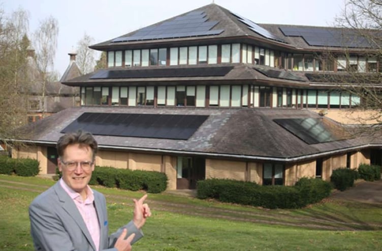 Council leader Cllr Jake Berriman points out the new solar panels installed on Powys County Hall in Llandrindod Wells