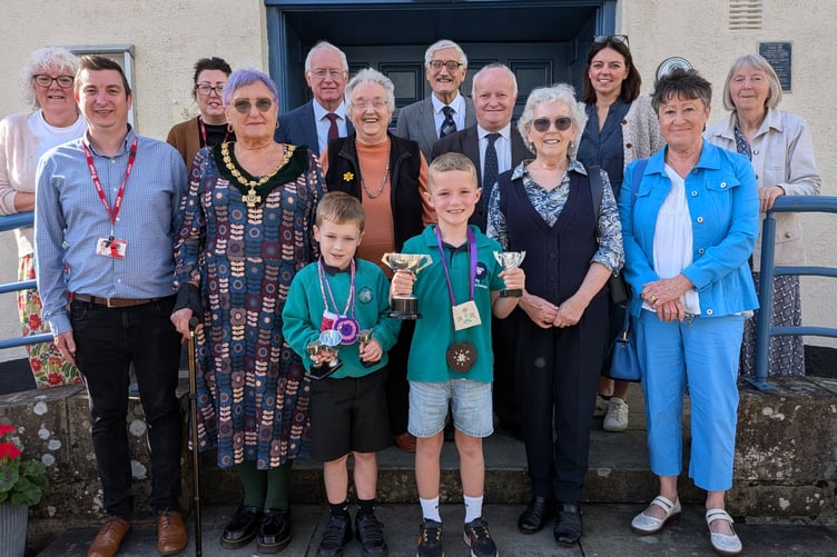Local winners Iori Hughes and Noa Rhys Price with, from left, Gill Lloyd, Chris Davies, Cath Williams, Lynda Pace Avery, Philip Watkins, Susan Price, Hywel Davies, Jonathan Morgan, Dr Delyth Hurley, Kate Knight, Gaenor Morris-Watkins and Heather Davis