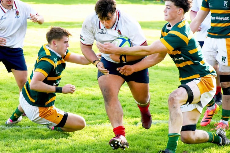 Llandovery prop Ollie Tucker bursts through to score his first try